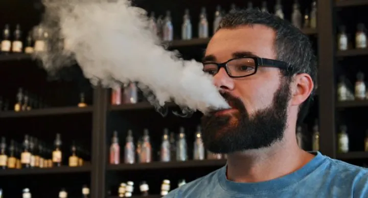Smoking an e-cigarette Smoking an e-cigarette